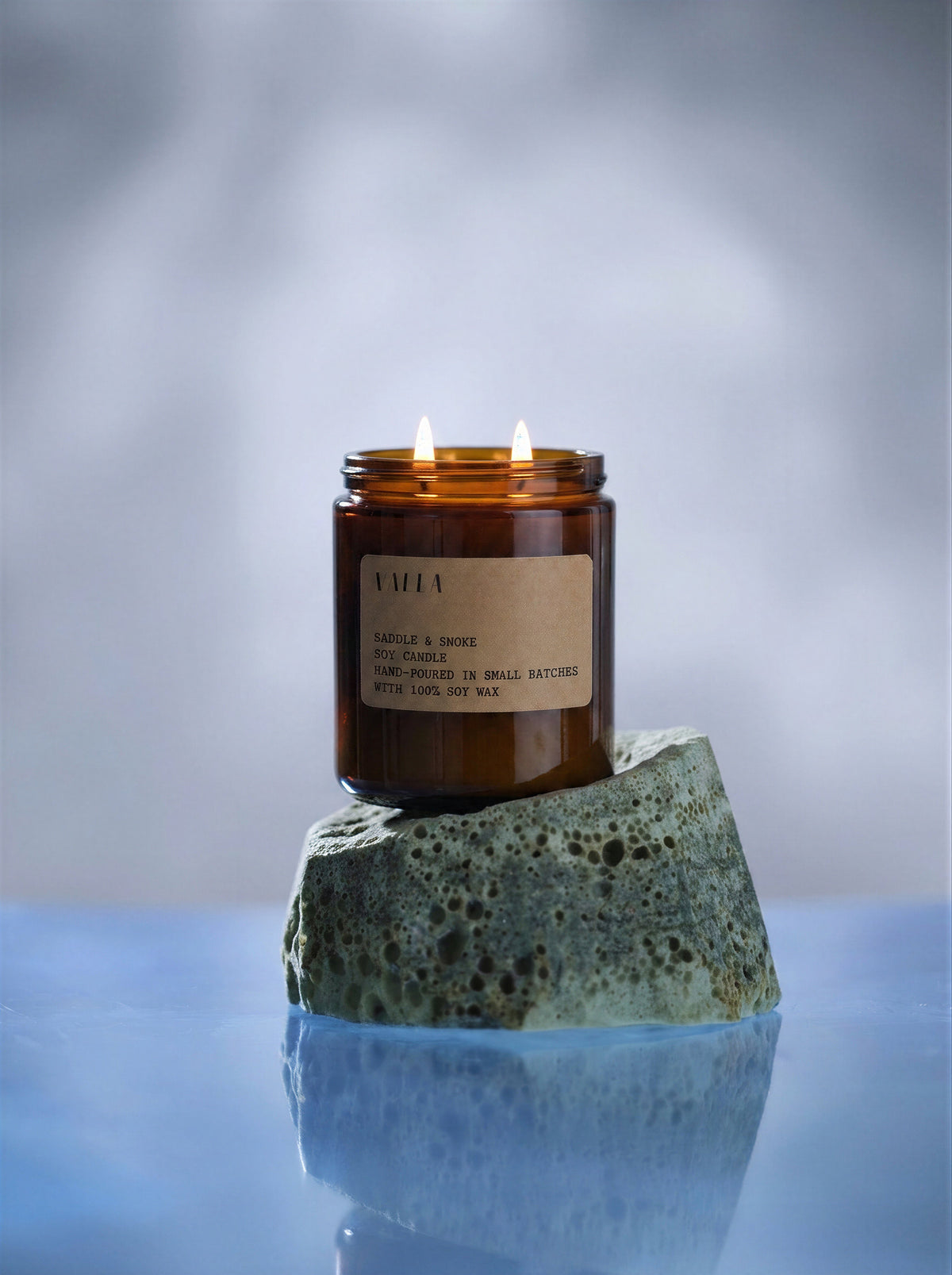 Salt Coast candle lit on a stone